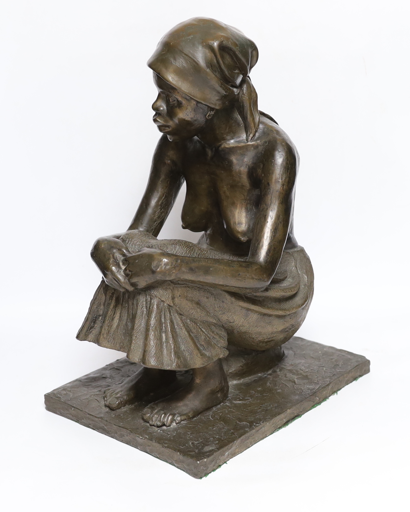 A bronzed resin figure of an African girl, signed J Cutler, 42cm high